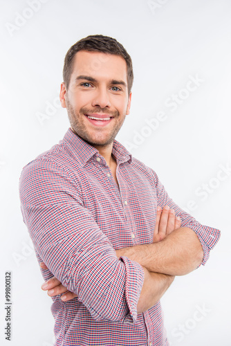 Close up portrait of smiling man with crossed hands © deagreez