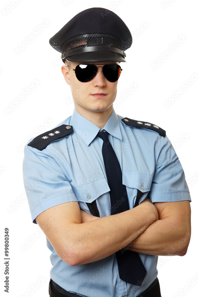 Portrait of young policeman in uniform with sunglasses Portrait of young policeman in uniform with sunglasses