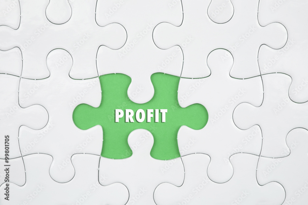 Jigsaw puzzle on color paper background with a word PROFIT Jigsaw puzzle on color paper background with a word PROFIT