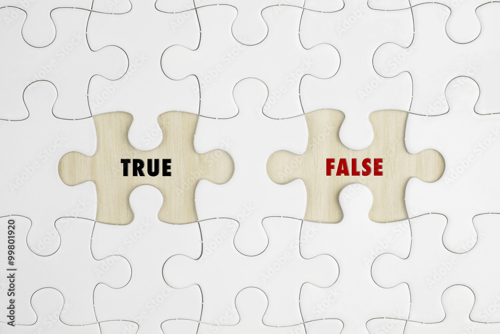 Jigsaw puzzle on wood background with a word TRUE and FALSE Jigsaw puzzle on wood background with a word TRUE and FALSE