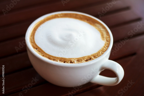 Coffee cup top view on wooden table background