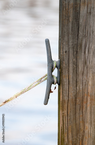 Dock cleat with rope to secure a boat