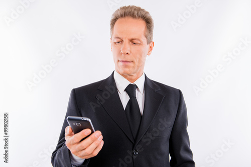 A handsome mature businessman with modern mobile phone