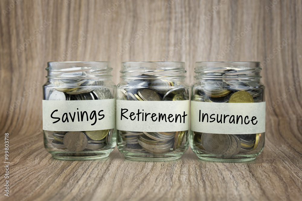 Coins in glass jar with saving, retirement and insurance label. Financial Concept