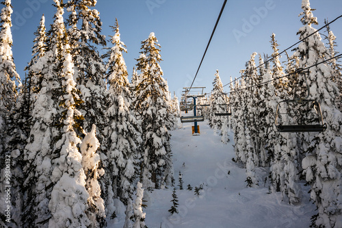 sitting on a ski resort chairlift in winter