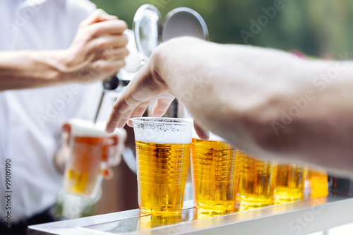 Sticker Man drawing beer. Hand takes beer plastic cup