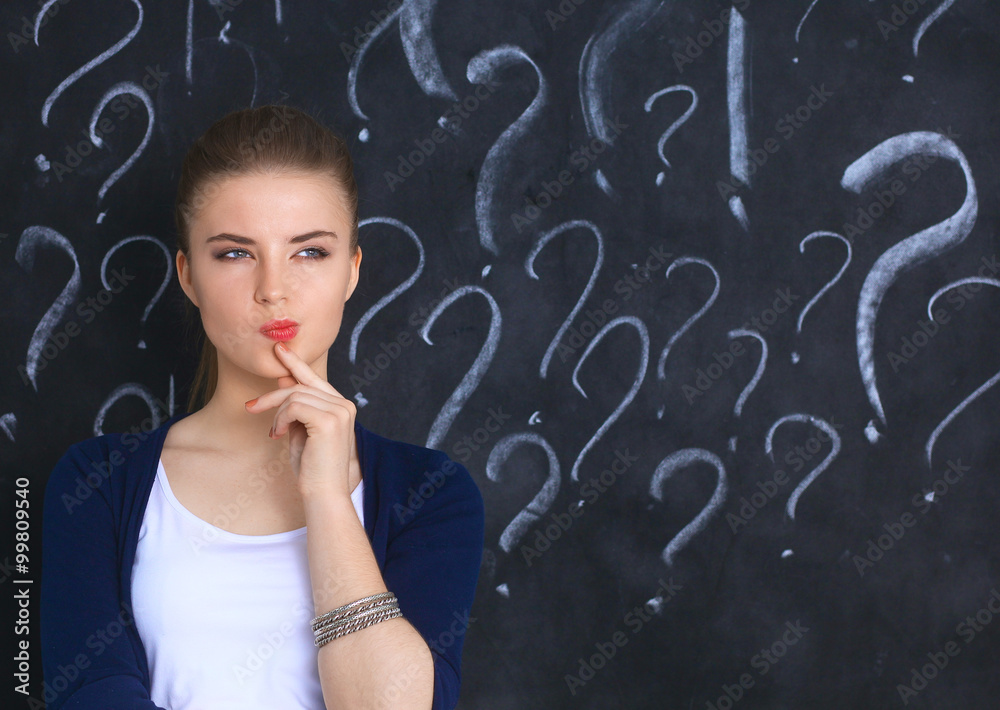 Young girl with question mark on a gray background Young girl with question mark on a gray background