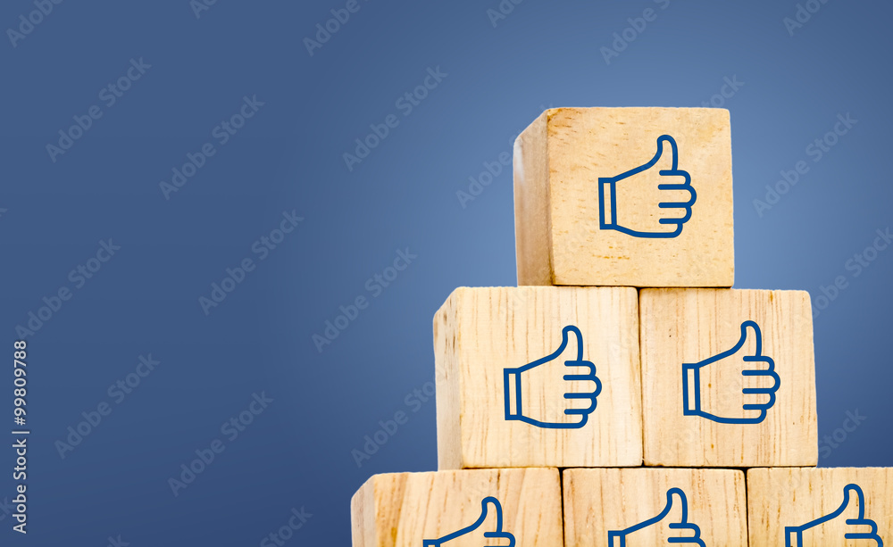 Thumb up icon on wood cube at dark blue background, leave space - obrazy, fototapety, plakaty 