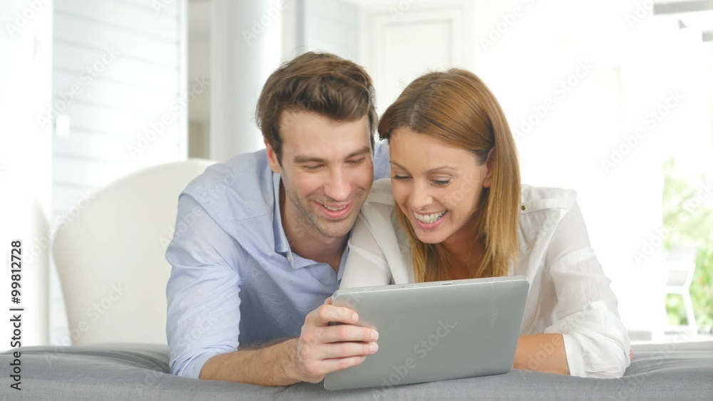 Couple having fun playing with tablet Couple having fun playing with tablet