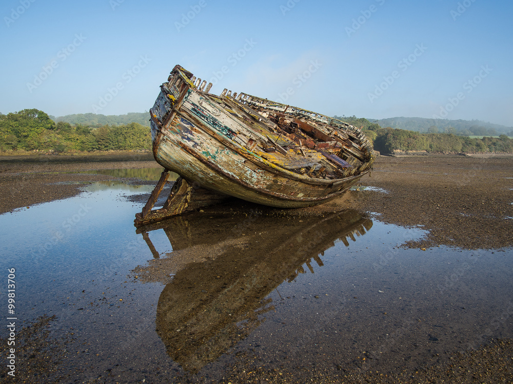 Boat wreck in Dulas estuary, Anglesey with reflection on a misty morning.