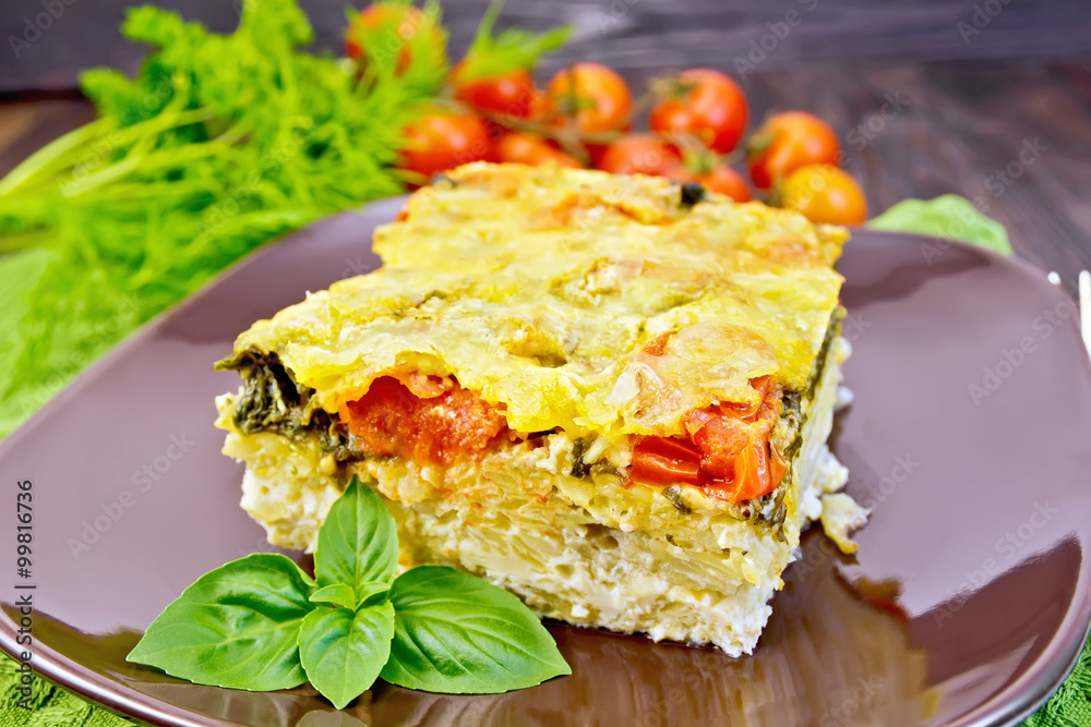 Pie potato with tomato and cheese on dark board Pie potato with tomato and cheese on dark board