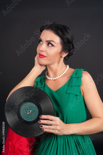 Pretty girl holding vinyl disc