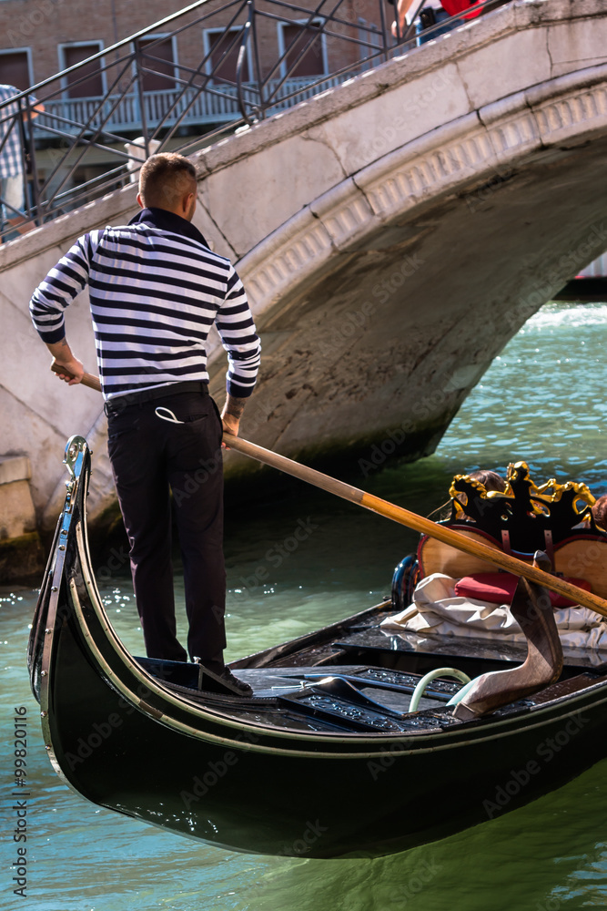 Gondolier in Venice Near Marble Bridge in Venice, Italy