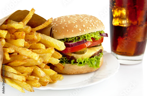 Closeup shot of cheeseburger,french fries,glass of cola on plate