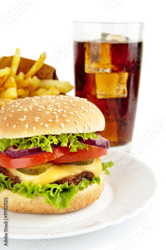 Cropped image of cheeseburger,french fries,glass of cola on plat