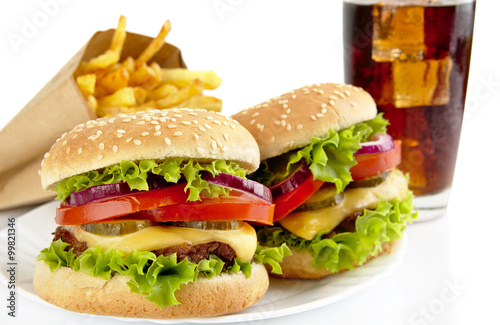 Set of two cheeseburgers,french fries,glass of cola on plate