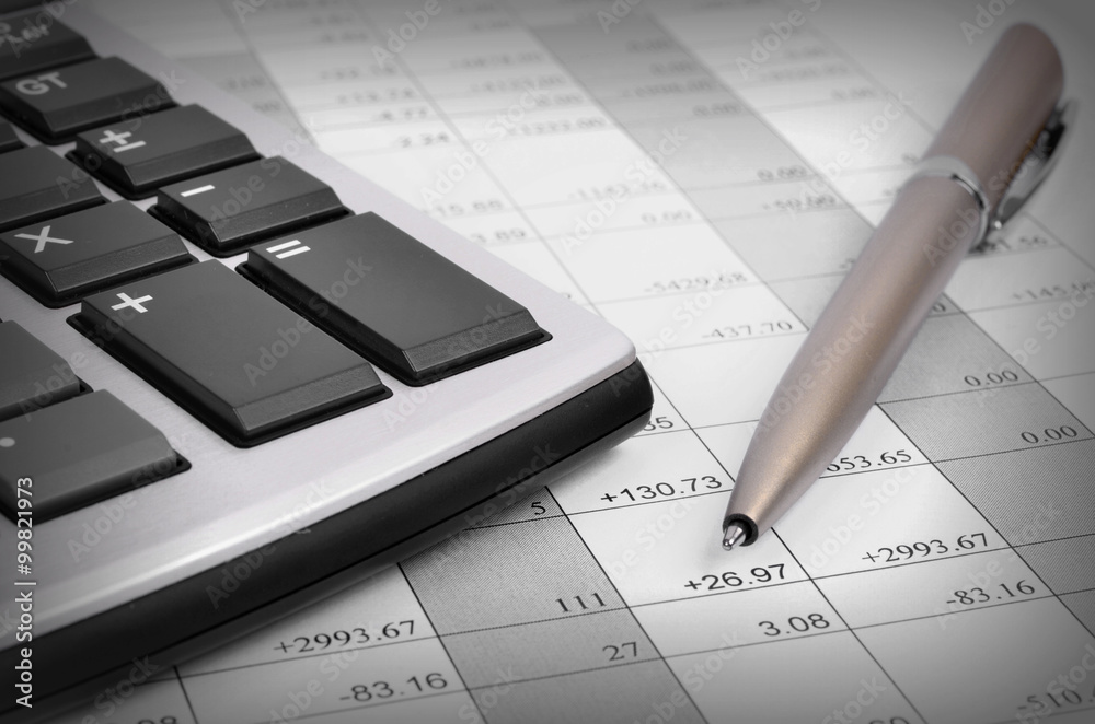 pen and calculator on a chart background pen and calculator on a chart background
