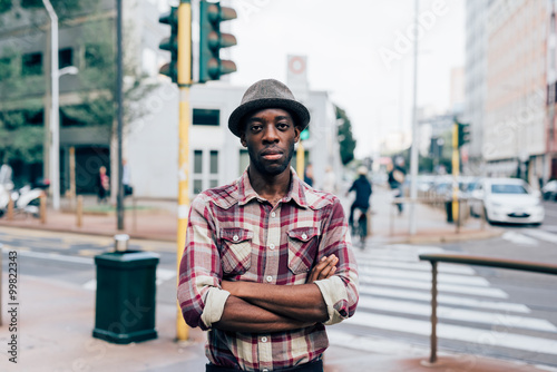 Half length of young handsome afro black man posing outdoor in t