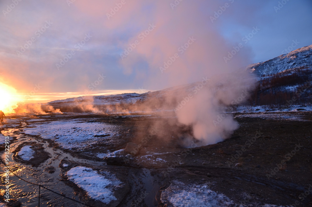 Steam is rising from a hot spring in Haukaladur in Iceland during sunset