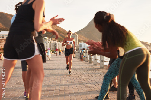 Young people encouraging race runners