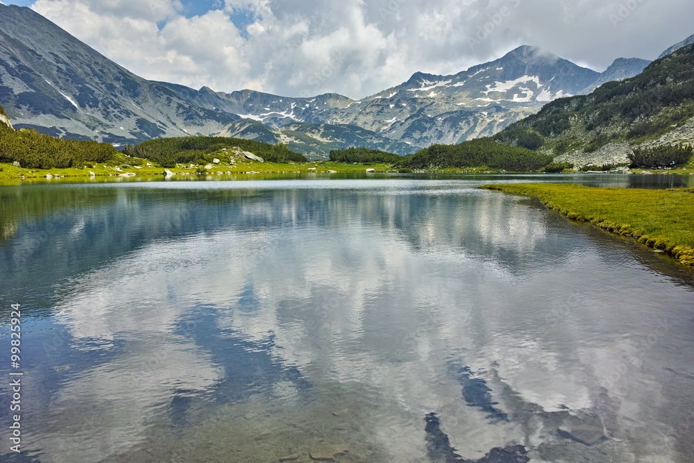 Amazing view of  Banderishki Chukar peak and reflection in Muratovo lake, Pirin Mountain, Bulgaria