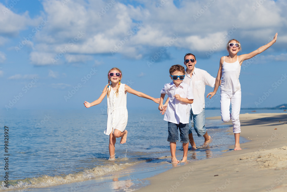 Father and children playing on the beach at the day time. Father and children playing on the beach at the day time.