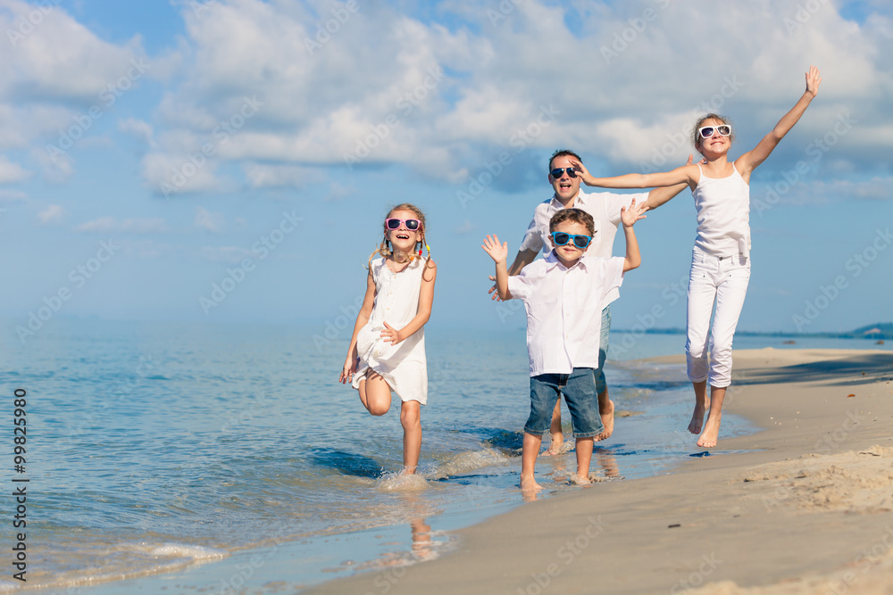 Father and children playing on the beach at the day time. Father and children playing on the beach at the day time.
