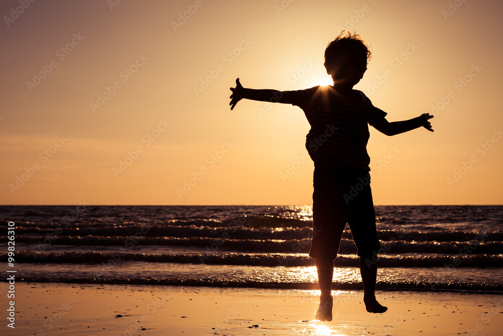 Happy little boy running on the beach