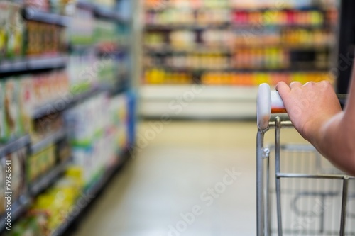 Detail of womans hand pushing cart