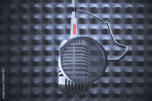Old style microphone at grey background