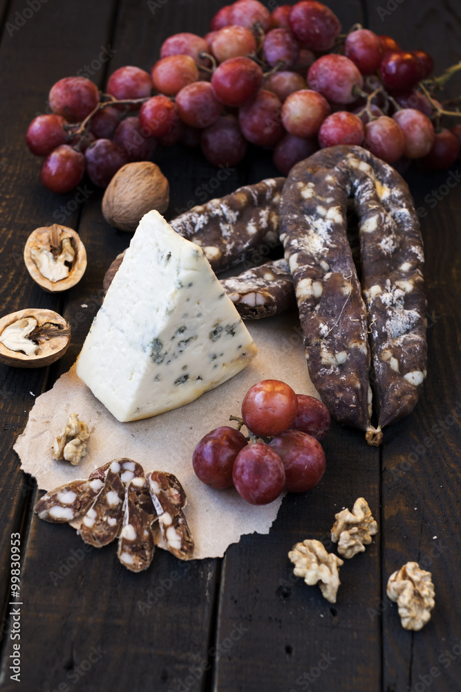 Snacks for wine, cheese with mold, pink grapes, walnuts