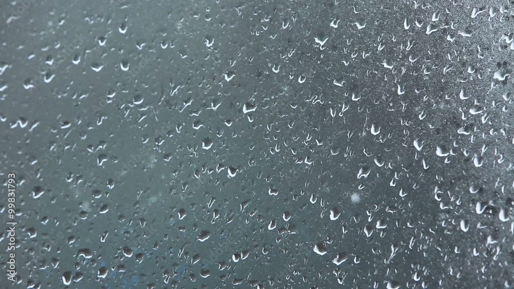 Rain, Large rain drops strike a window during a shower Rain, Large rain drops strike a window during a shower