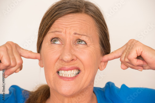 Frustrated woman covering ears