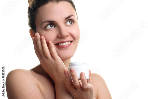 Women apply moisturizer on your face on a white isolated background