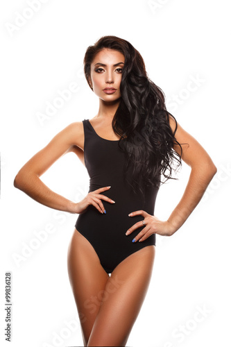 Beautiful and attractive girl with thick wavy hair and sexy figure posing in the black body 