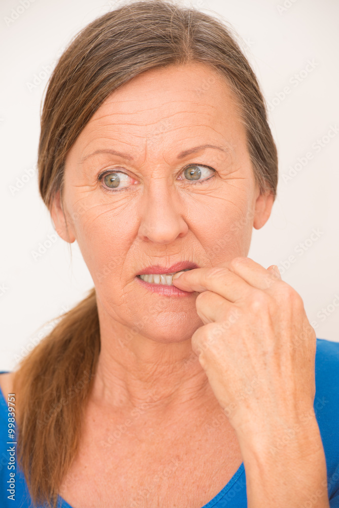 Fototapeta premium Nervous woman biting finger