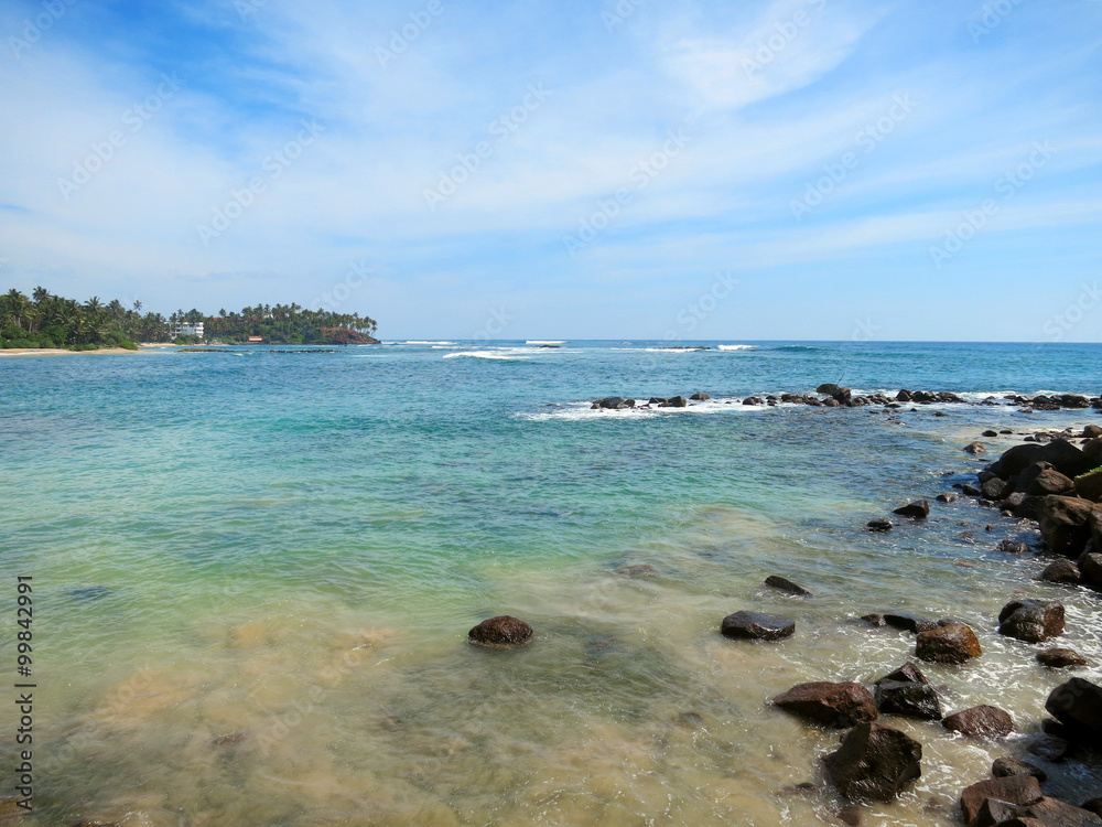 Mirissa bay with rocks, greens and ocean waves, Sri Lanka
