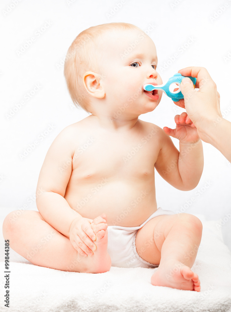 Little baby girl learning to brush teeth with mother's help Little baby girl learning to brush teeth with mother's help