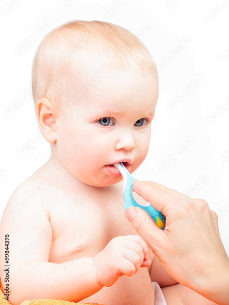 Little baby girl learning to brush teeth with mother's help Little baby girl learning to brush teeth with mother's help