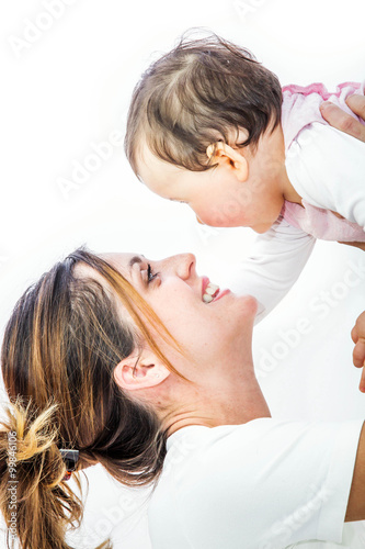 close-up of a smiling young woman with her baby on white background