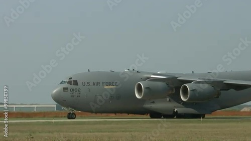 Close view of Boeing C-17 Globemaster military transport taxiing at airfield. Used by the United States Air Force and developed by McDonnell Douglas.  Recorded in 4K, ultra high definition.
