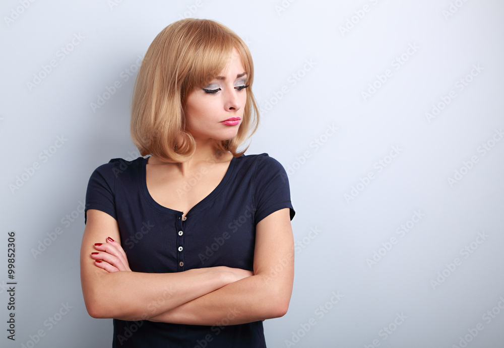 Resentful unhappy casual woman with short blond hair looking dow