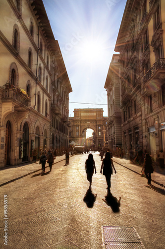 Florence street scene on the via degli speziali, backlit HDR with silhouettes in the street