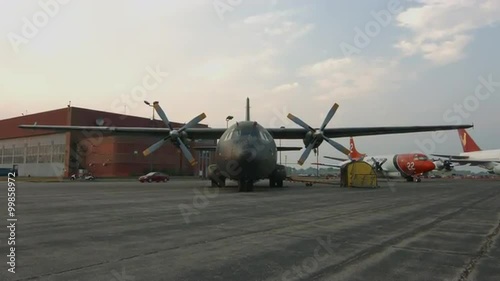 Tilt from tarmac to wide view of Transall C-160 military transport plane, developed by France and Germany, parked at airfield in USA.  Recorded in 4K, ultra high definition. photo