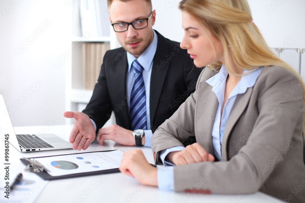 Two successful business partners working at meeting in office Two successful business partners working at meeting in office