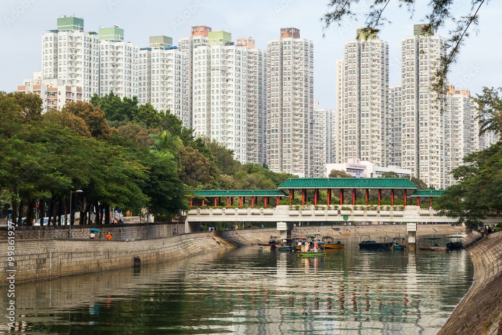 Fototapeta premium View of a river, bridge and residential buildings in Tai Po New Town, Hong Kong, China.