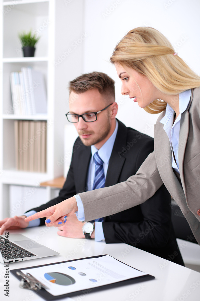 Two successful business partners working at meeting in office Two successful business partners working at meeting in office