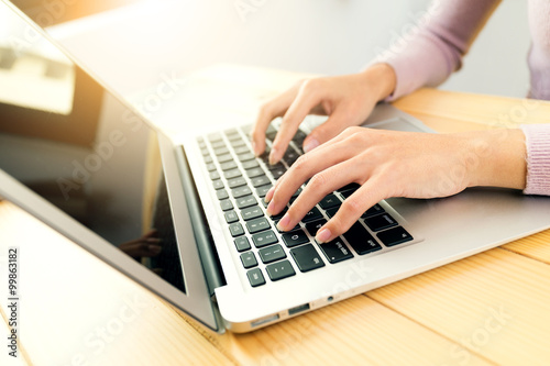 Woman typing on notebook computer