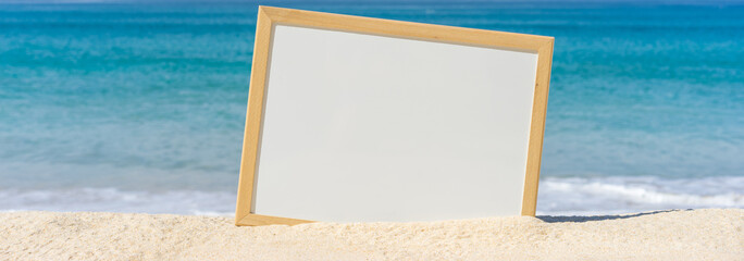White board on the beach for your text. wide banner.