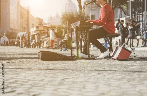 Fototapeta Naklejka Na Ścianę i Meble -  street artist playing the piano while singing